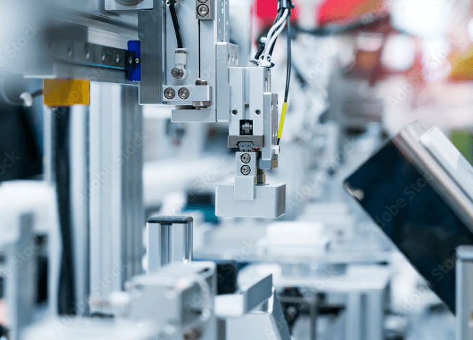 精密な産業用機械が自動化された生産ラインで稼働している様子を示す画像。